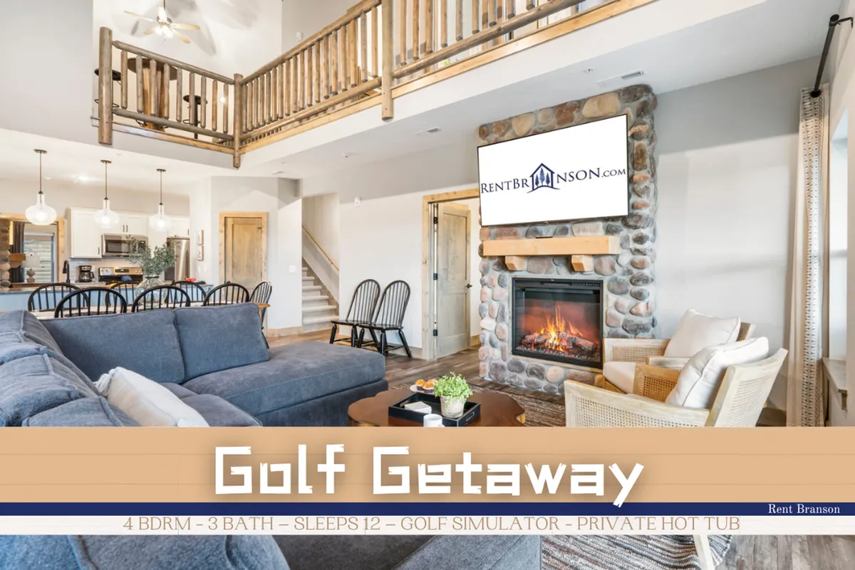 A spacious entertainment loft with a large sectional sofa arranged by a stone fireplace, a golf simulator screen visible in the background, wooden railing, and an open dining area. The setup feels cozy yet recreational, encouraging both active and relaxed group gatherings.